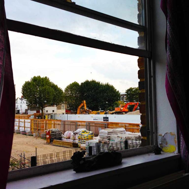 View from the 1st floor of No 8 Wheatstone House. A building site that has replaced Athlone Gardens in preparation for the building of Portobello Square. In the background are orange diggers and excavating machinery. Photo by Natasha Langridge, 2014.