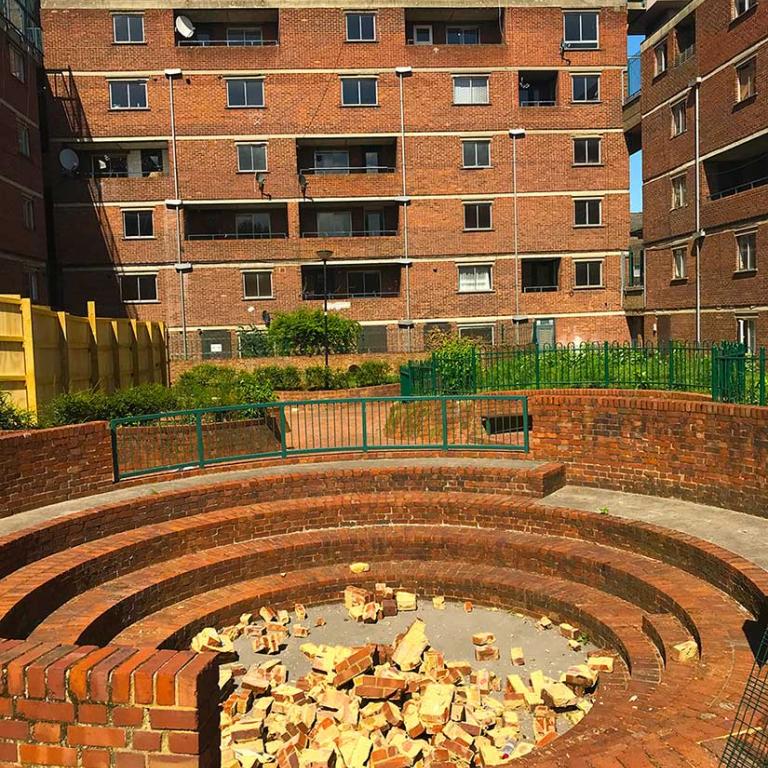 A shower of bricks filling the amphitheatre at the back of Murchison House which is in the process of being demolished. In the background is Wells House. Photo by Natasha Langridge, 2018.