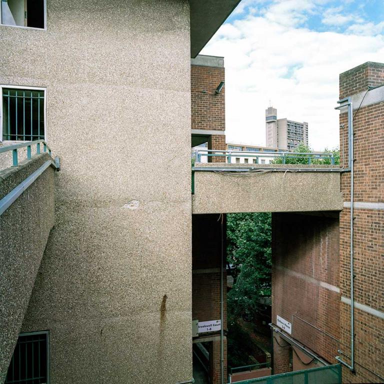 A view North-East from the 4th floor walkway of Chesterton House, across the estate. Trellick Tower can be seen in the distance. Photo by Kevin Percival, a resident of Pepler House, 2019.