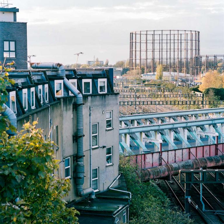 A view West and slightly North from Thompson House stairwell. Paddington mainline stretches out towards Kensington Gasworks on the right of the frame. Photo by Kevin Percival, a resident of Pepler House, 2019.